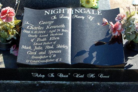 Low rise memorial in a wave shape crafted from granite by Stoneworx - Memorials of Distinction in New Zealand.