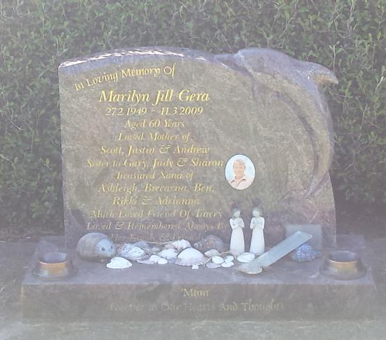 Custom memorial headstone with a rough top and carved dolphin crafted from granite by Stoneworx - Memorials of Distinction in New Zealand.