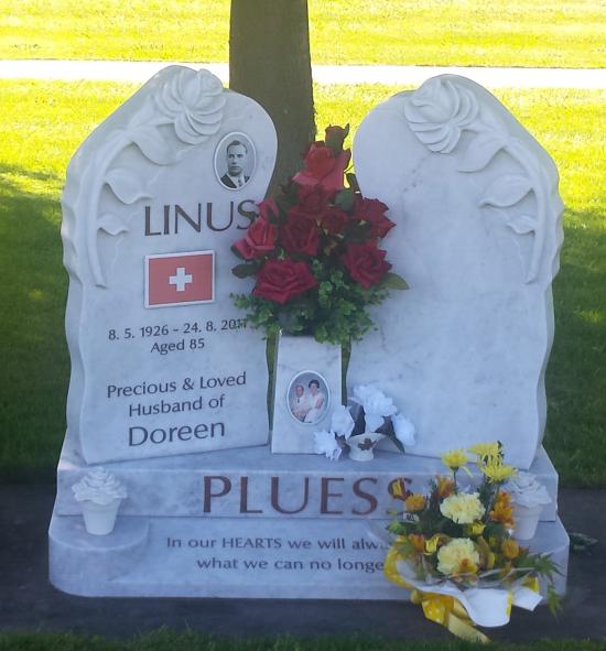 Custom double headstone in irregular shape with carved flowers  crafted from granite by Stoneworx - Memorials of Distinction in New Zealand.