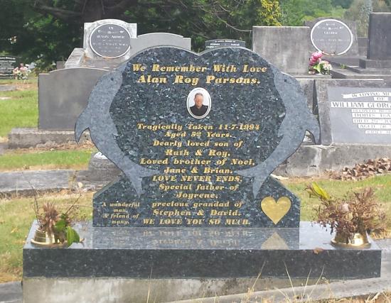 Custom headstone in an heart shape with dolphins crafted from granite by Stoneworx - Memorials of Distinction in New Zealand.