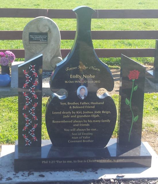 Custom design headstone in the shape of a patu with side panels crafted from granite by Stoneworx - Memorials of Distinction in New Zealand.