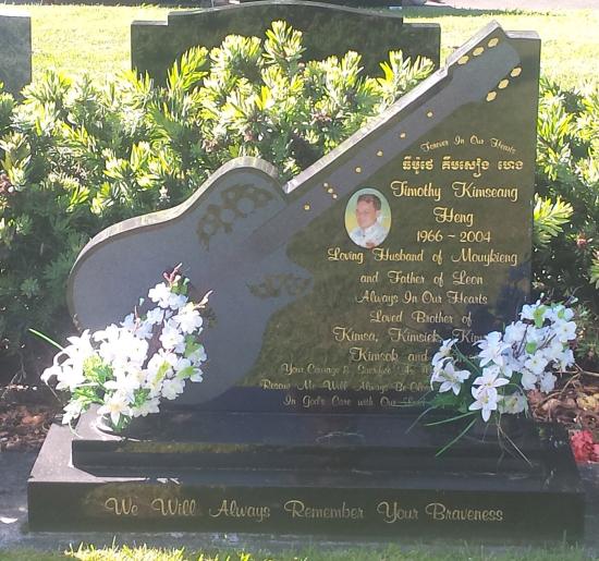 Custom headstone design with a carved guitar crafted from granite by Stoneworx - Memorials of Distinction in New Zealand.