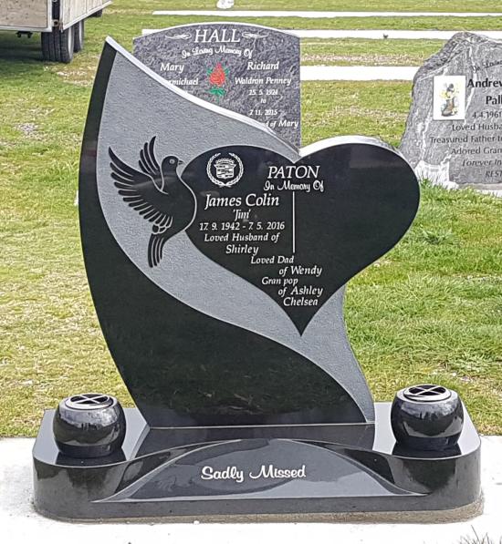 A custom shape headstone with heart and dove crafted from granite by Stoneworx - Memorials of Distinction in New Zealand.