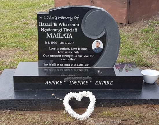 A custom shape headstone with a koru  crafted from granite by Stoneworx - Memorials of Distinction in New Zealand.