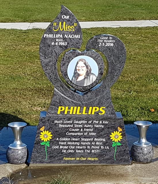 Custom headstone with heart surrounded by stylised dolphins crafted from granite by Stoneworx - Memorials of Distinction in New Zealand.