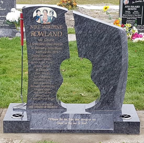 A custom shape headstone with guitar reverse cutout crafted from granite by Stoneworx - Memorials of Distinction in New Zealand.