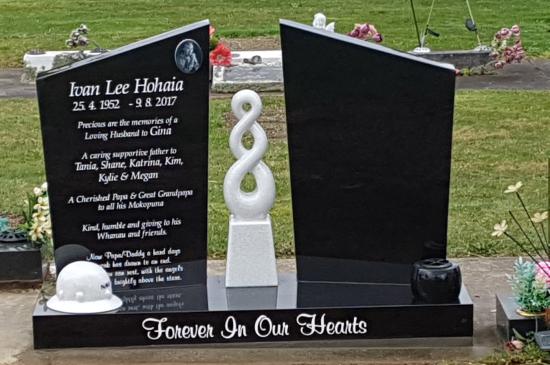 Companion headstone with a koru carved in the centre crafted from granite by Stoneworx - Memorials of Distinction in New Zealand.