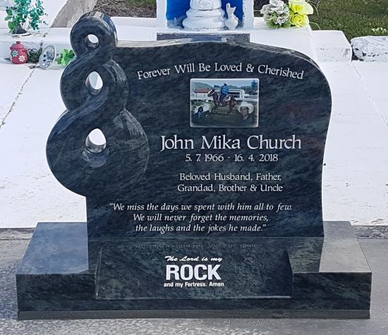 Custom headstone with a carved koru crafted from granite by Stoneworx - Memorials of Distinction in New Zealand.