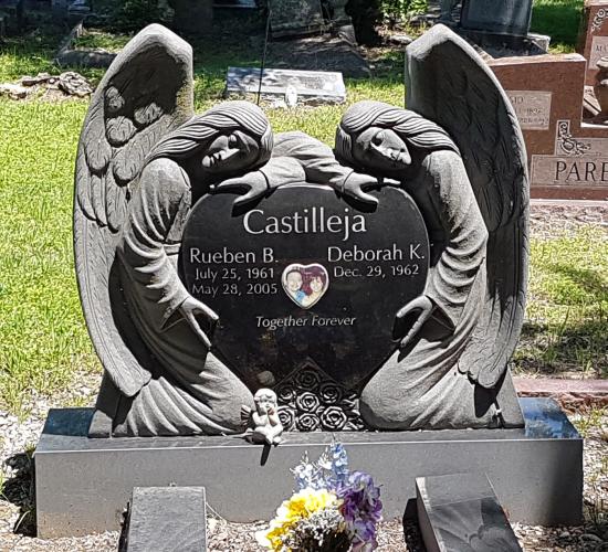 Custom headstone with two angels draped over a heart shaped headstone crafted from granite by Stoneworx - Memorials of Distinction in New Zealand.