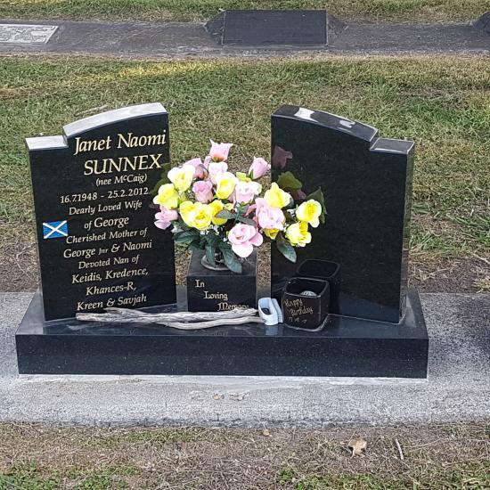 Custom headstone - a split low saddle with checks crafted from granite by Stoneworx - Memorials of Distinction in New Zealand.