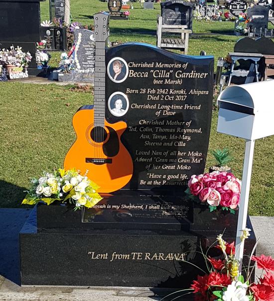 Custom headstone design with a guitar shape crafted from granite by Stoneworx - Memorials of Distinction in New Zealand.