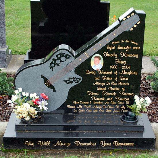 Custom headstone with guitar shape crafted from granite by Stoneworx - Memorials of Distinction in New Zealand.