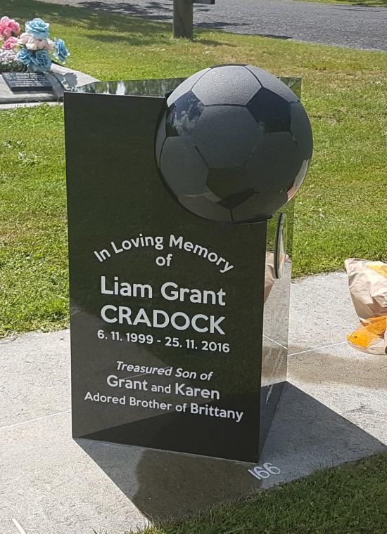 Custom headstone with football crafted from granite by Stoneworx - Memorials of Distinction in New Zealand.