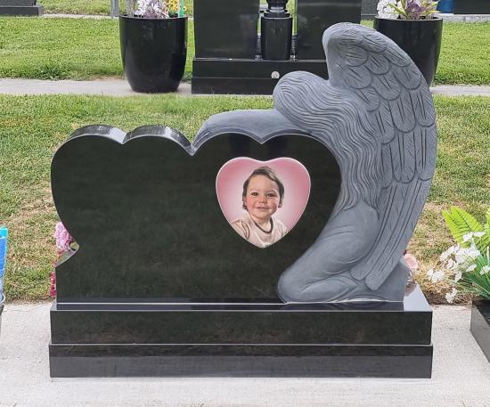 Double heart custom headstone with a carved angel crafted from granite by Stoneworx - Memorials of Distinction in New Zealand.