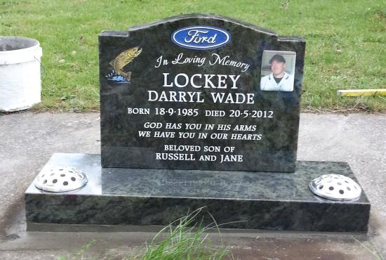 Classic upright headstone with high saddle top and two vases crafted from black granite by Stoneworx - Memorials of Distinction in New Zealand.