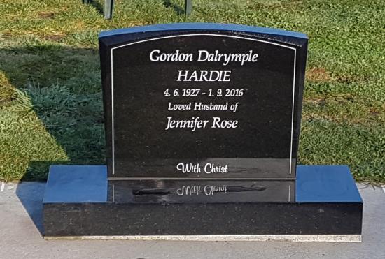 Classic upright headstone with low saddle top crafted from granite by Stoneworx - Memorials of Distinction in New Zealand.