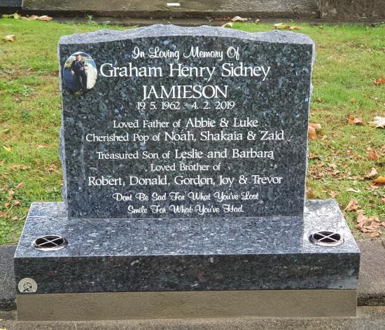 Classic upright headstone with low saddle top crafted from granite by Stoneworx - Memorials of Distinction in New Zealand.