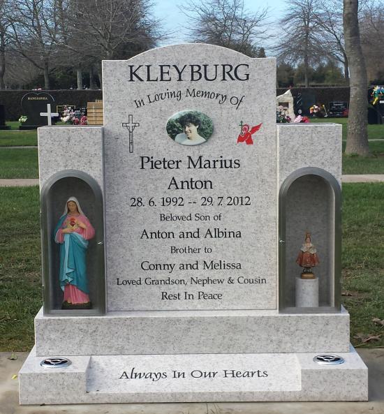 Custom headstone in light grey crafted from granite by Stoneworx - Memorials of Distinction in New Zealand.