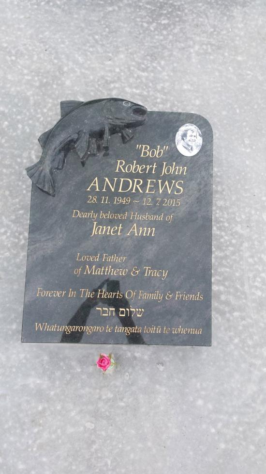Low rise memorial in a square shape with fish design crafted from granite by Stoneworx - Memorials of Distinction in New Zealand.