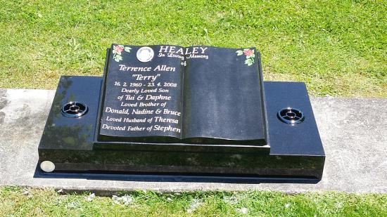 Low rise memorial in a book shape crafted from granite by Stoneworx - Memorials of Distinction in New Zealand.